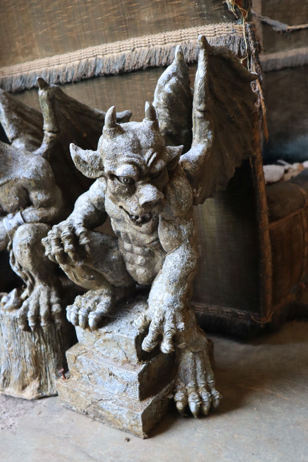 Three composition gargoyle garden ornaments and a reconstituted stone garden ornament, tallest 60cm